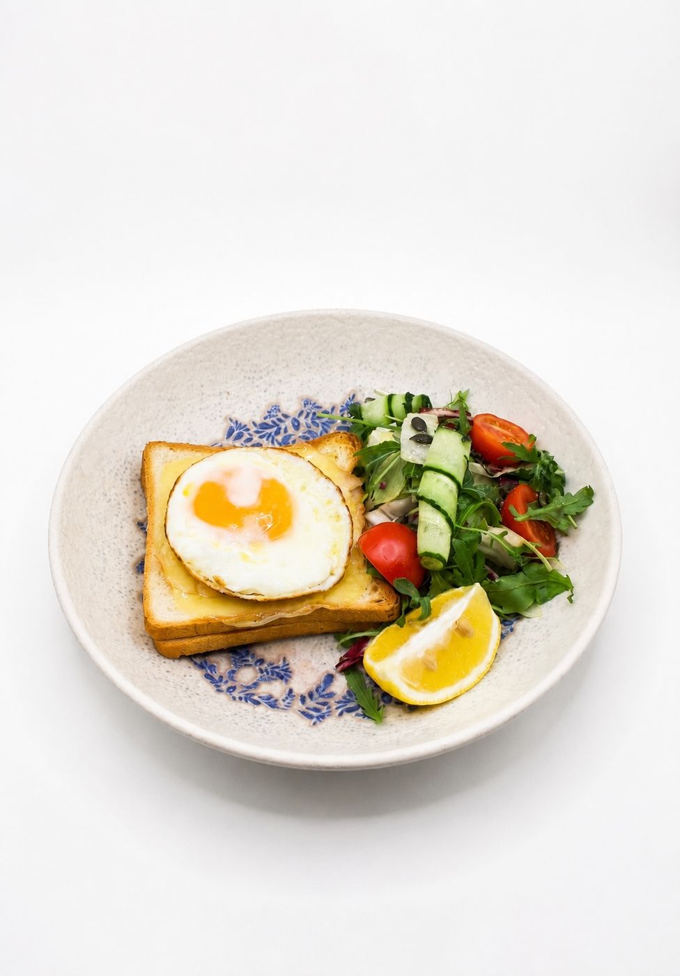 Fried egg on toast with salad